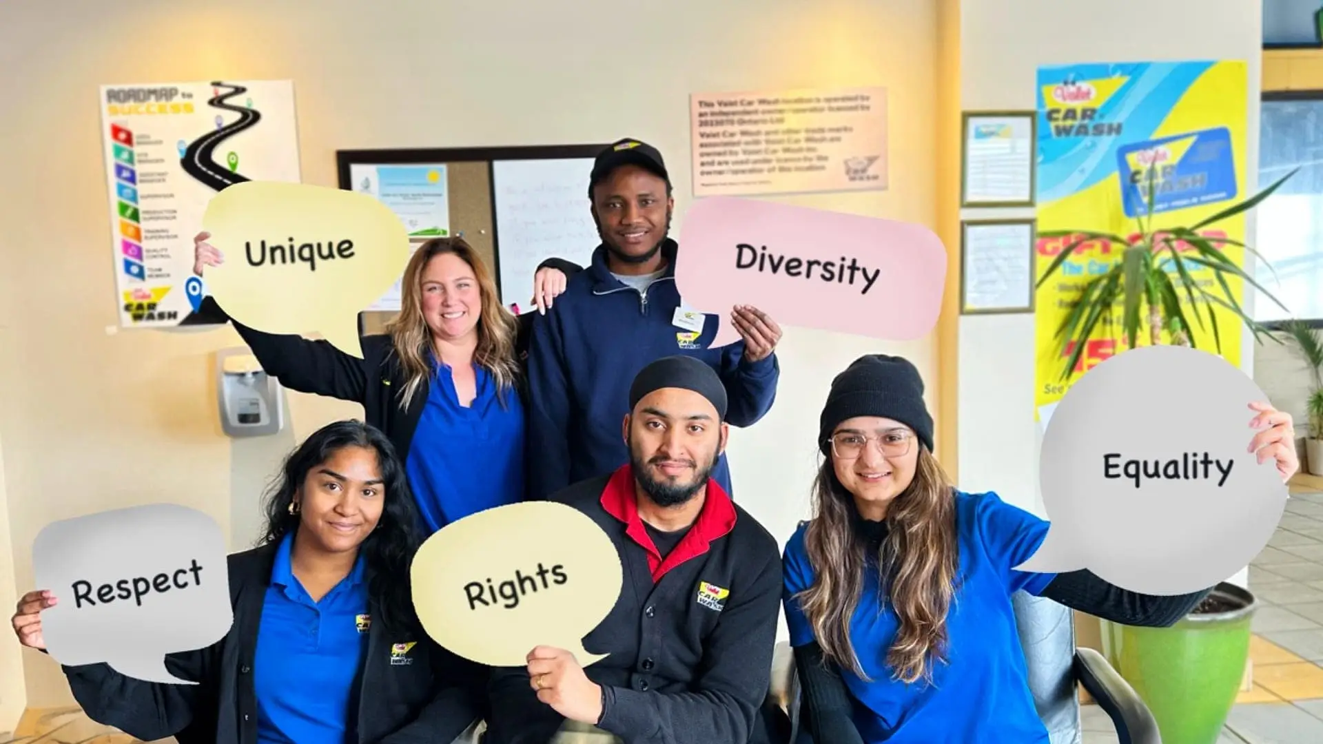 Group photo of diverse Valet Car Wash employees, holding speech bubble signs that say "Unique", "Diversity", "Equality", "Respect" and "Rights"