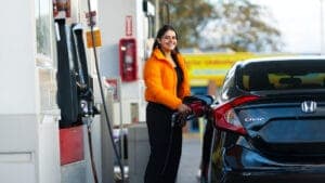 Happy customer filling up her car with gas