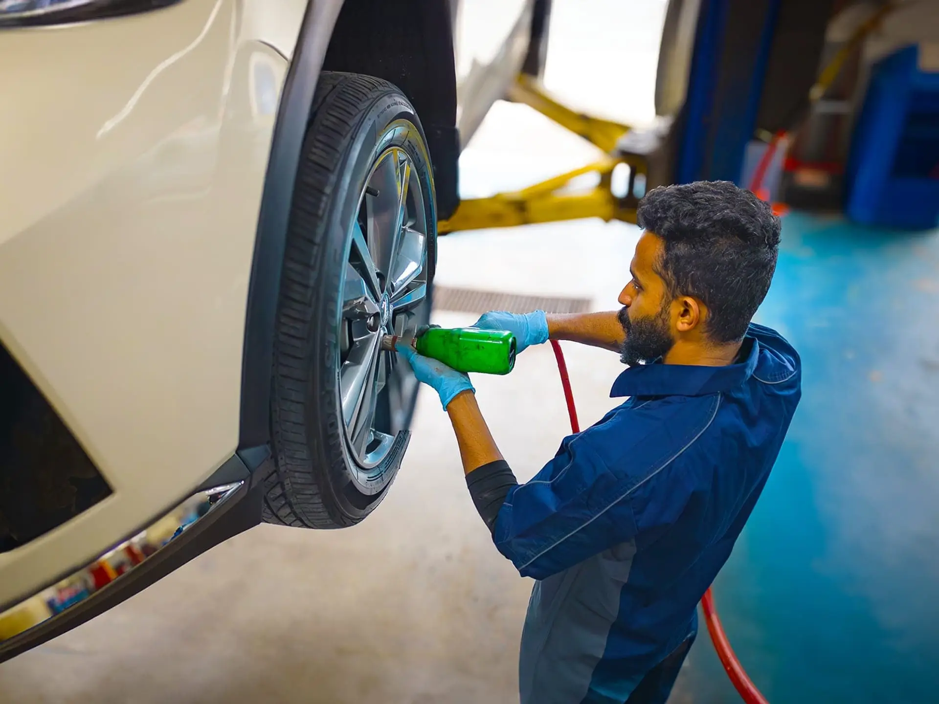 Valet technician bolting in new tire