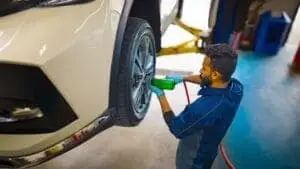 Valet technician bolting in new tire