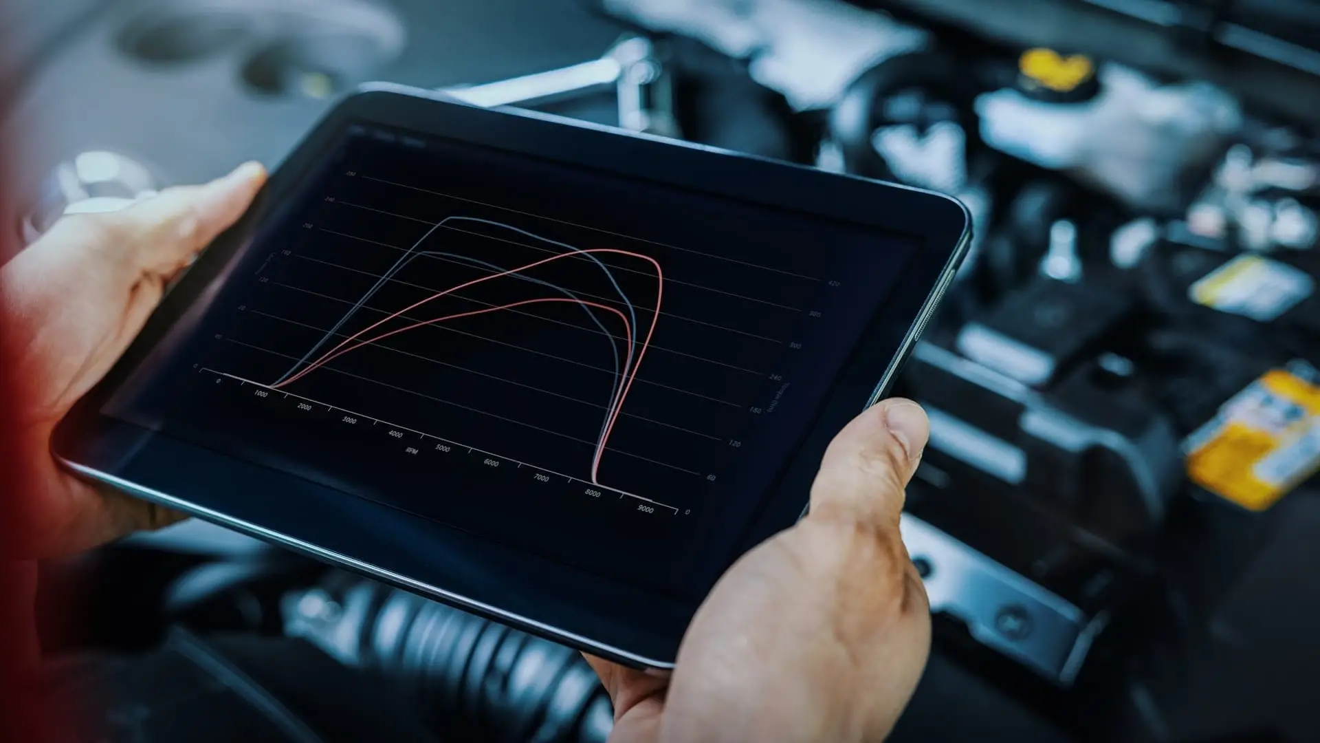 Valet technician using software diagnostics on engine