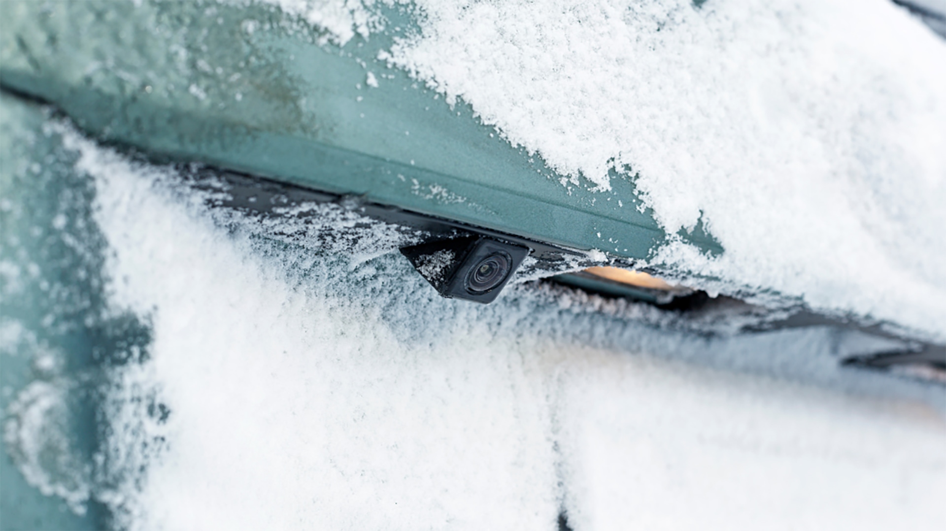 Picture of a car rear parking sensor on a frozen bumper