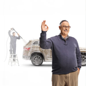 Picture of a senior person making the OK sign while a Valet employee washes his SUV