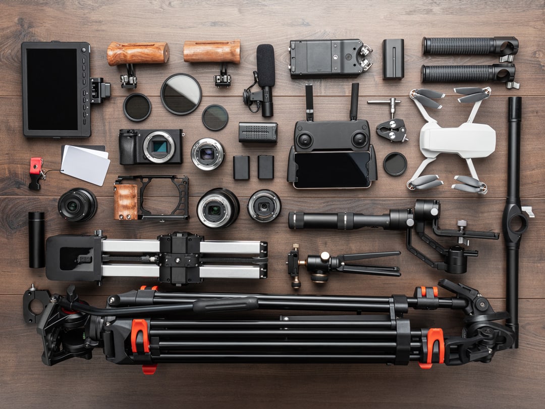 A picture of camera gear knolled on a wooden table