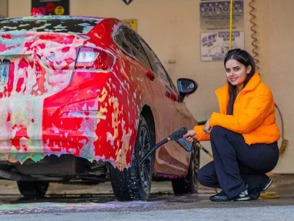 Picture of a person saving water by using our self car wash